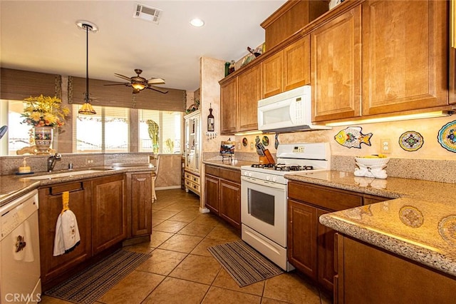 kitchen featuring white appliances, sink, ceiling fan, light tile patterned floors, and decorative light fixtures