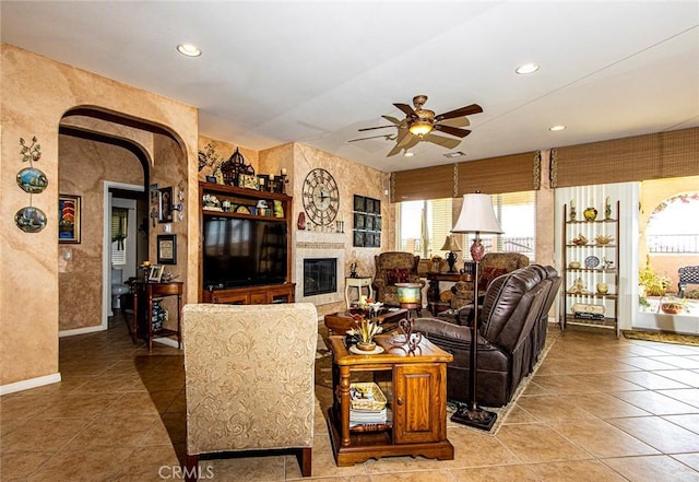 living room with ceiling fan and tile patterned flooring