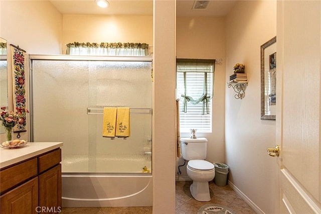 full bathroom with tile patterned flooring, vanity, toilet, and shower / bath combination with glass door