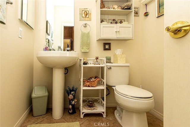 bathroom with sink, tile patterned flooring, and toilet