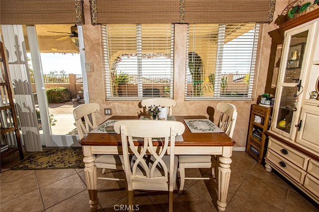 tiled dining room featuring ceiling fan