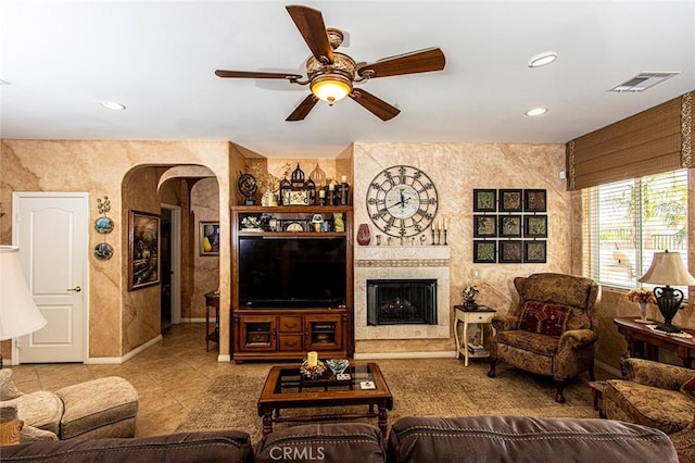 living room with light tile patterned floors and ceiling fan