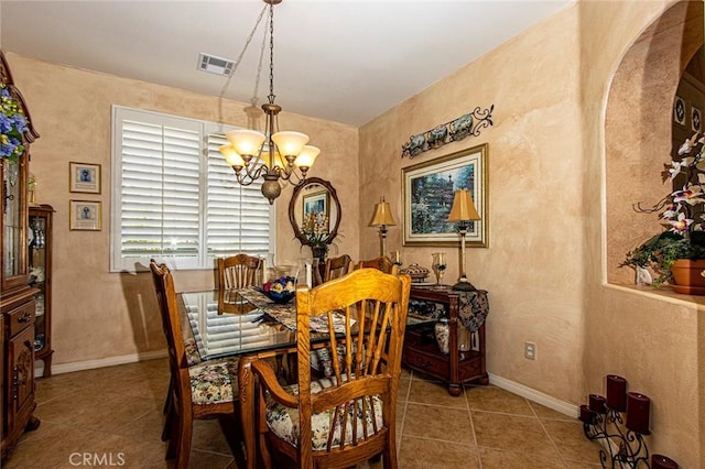 tiled dining space with a notable chandelier