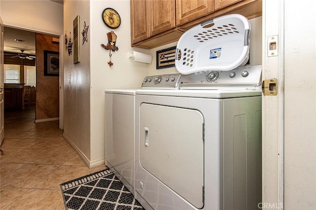 laundry area with ceiling fan, light tile patterned flooring, cabinets, and independent washer and dryer