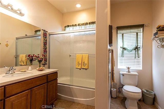 full bathroom with toilet, vanity, tile patterned floors, and enclosed tub / shower combo