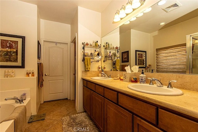 bathroom with a bathing tub, tile patterned flooring, and vanity