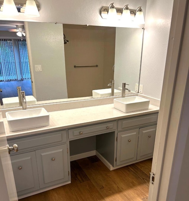 bathroom with ceiling fan, vanity, and hardwood / wood-style flooring