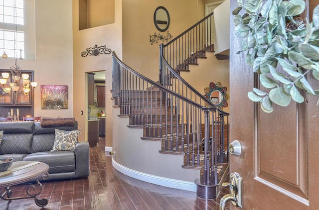 foyer with a chandelier, dark hardwood / wood-style flooring, and a high ceiling