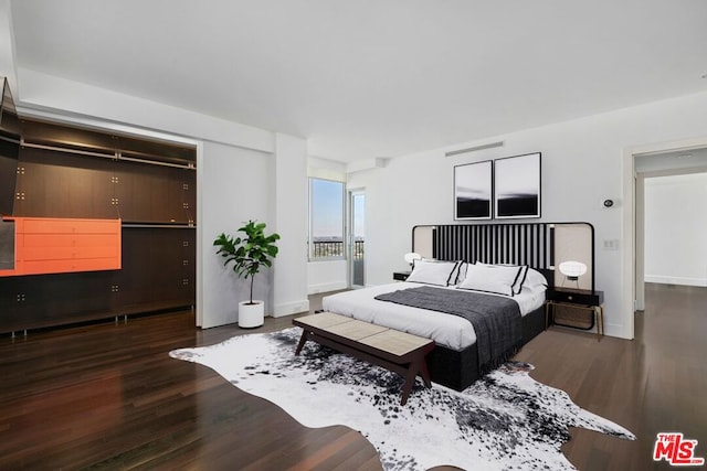 bedroom with dark hardwood / wood-style flooring