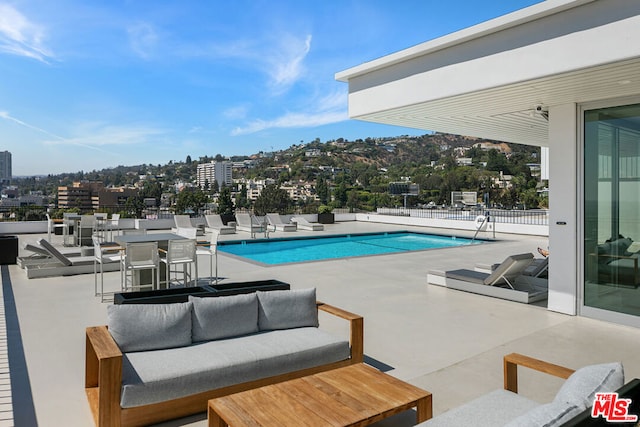 view of pool with a patio area and an outdoor hangout area