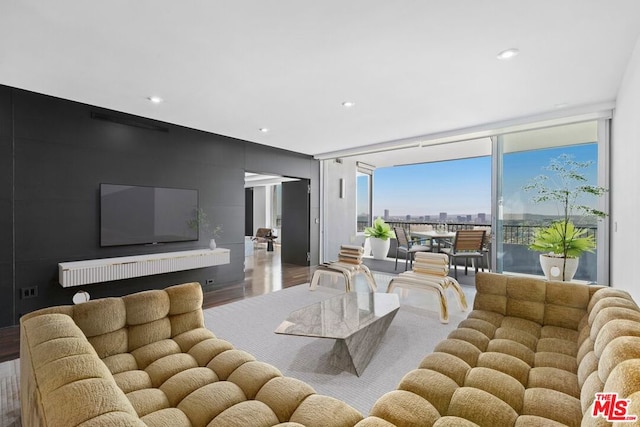 living room with hardwood / wood-style flooring and floor to ceiling windows