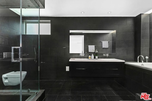 full bathroom featuring tile patterned floors, toilet, vanity, independent shower and bath, and tile walls