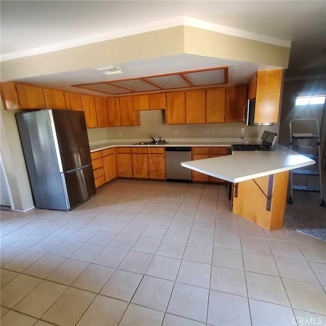 kitchen with a kitchen breakfast bar, sink, light tile patterned floors, kitchen peninsula, and stainless steel appliances