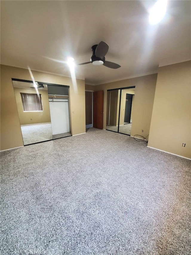 unfurnished bedroom with carpet flooring and ceiling fan