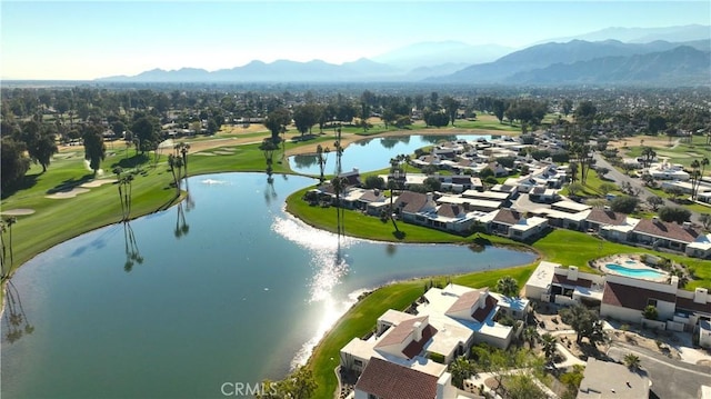 birds eye view of property with a water and mountain view