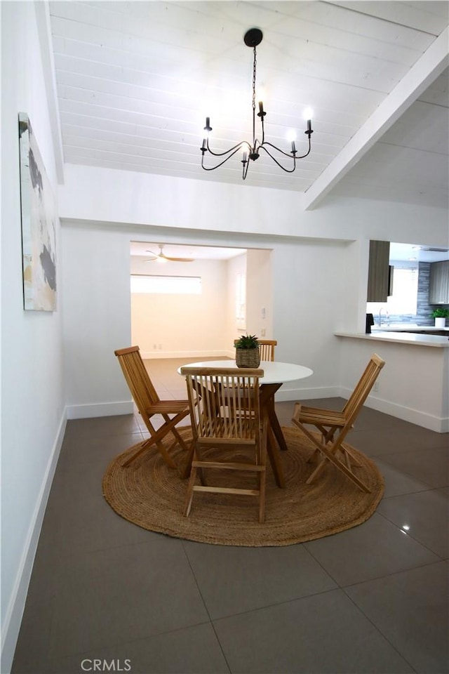 tiled dining room featuring a notable chandelier and beamed ceiling