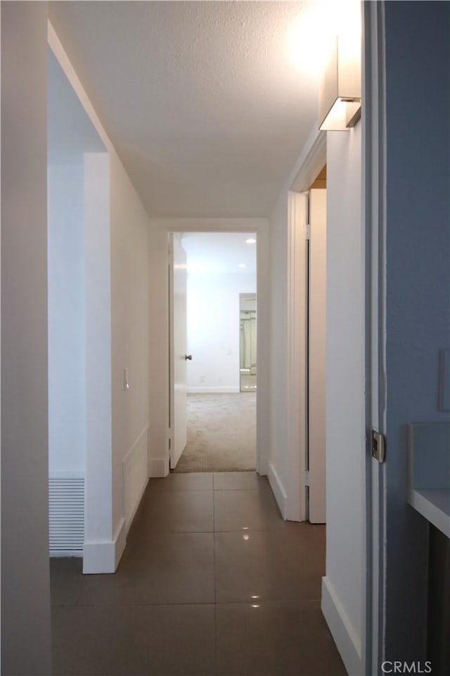 corridor featuring tile patterned flooring