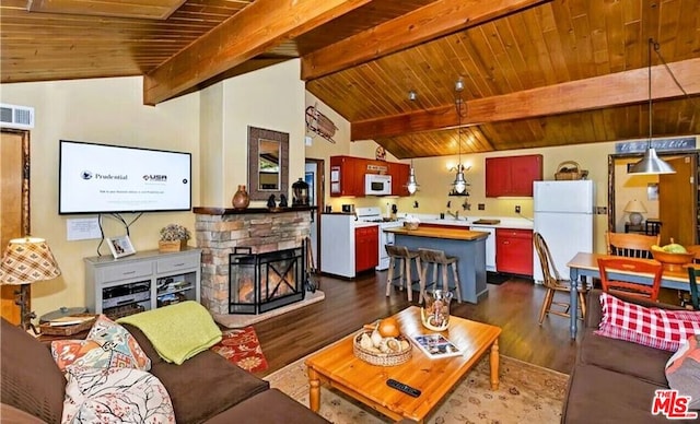 living room with wood ceiling, vaulted ceiling with beams, dark hardwood / wood-style floors, and a stone fireplace