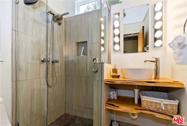 bathroom featuring walk in shower and vanity