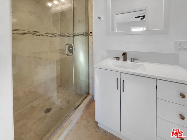 bathroom featuring vanity and a shower with shower door