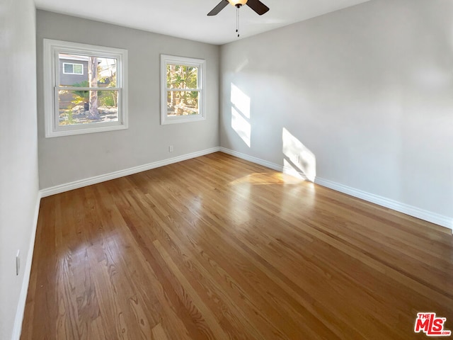 unfurnished room with ceiling fan and light hardwood / wood-style flooring