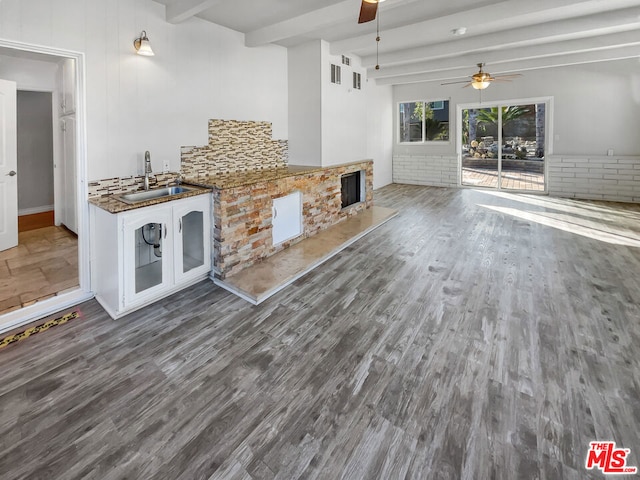 kitchen featuring white cabinets, sink, hardwood / wood-style flooring, ceiling fan, and beam ceiling