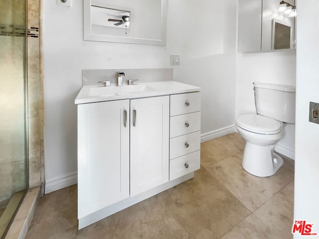 bathroom with vanity, ceiling fan, tile patterned flooring, toilet, and a shower with shower door