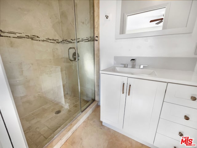 bathroom featuring vanity, walk in shower, and ceiling fan