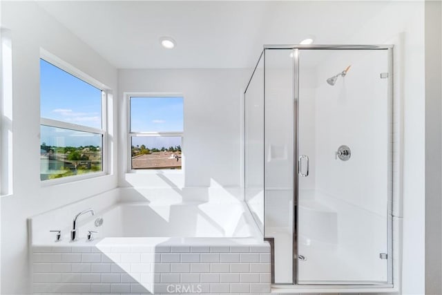 bathroom featuring a water view and shower with separate bathtub