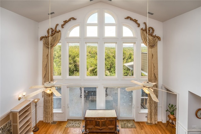 unfurnished sunroom with ceiling fan