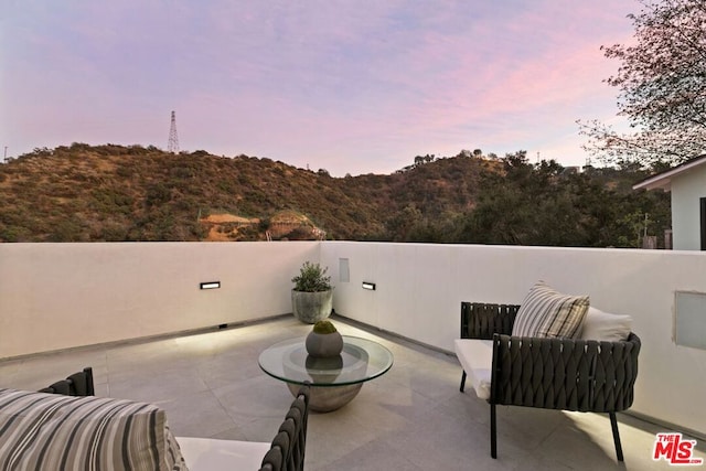 view of patio terrace at dusk