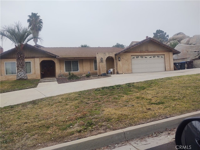 ranch-style home with a front yard and a garage