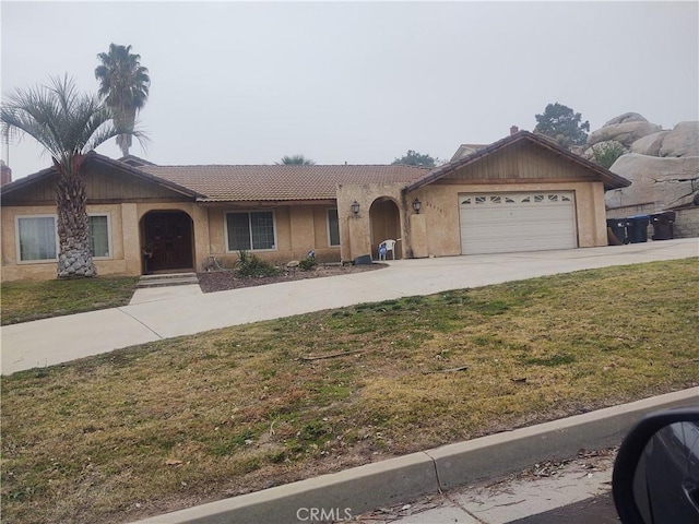 ranch-style home featuring a front yard and a garage