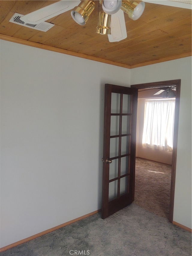 spare room featuring carpet floors, french doors, wood ceiling, and ornamental molding