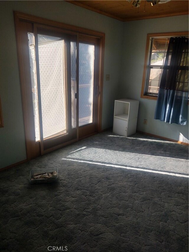 carpeted spare room with an inviting chandelier