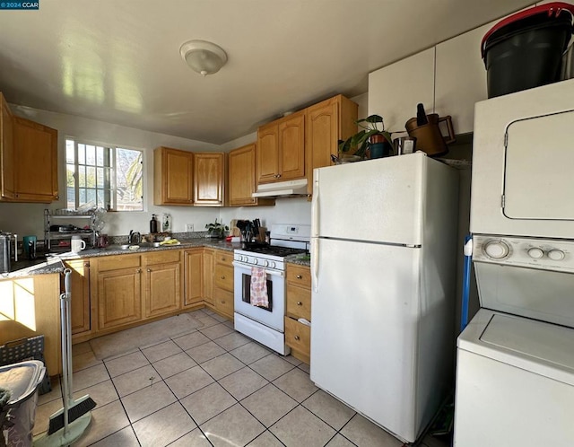 kitchen with light tile patterned floors, white appliances, and sink