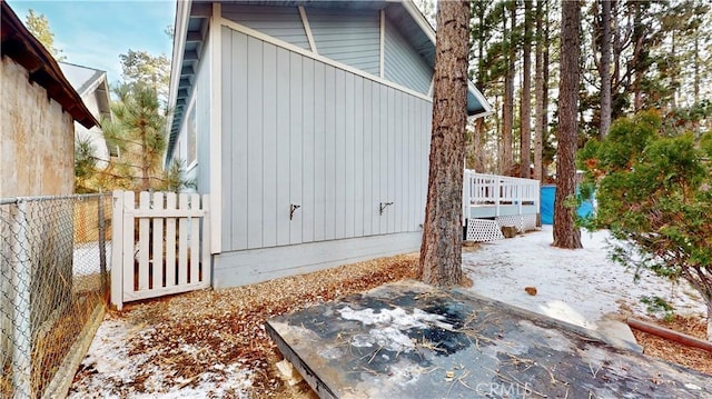 view of snowy exterior with a deck