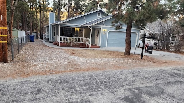 view of front of property with a porch and a garage