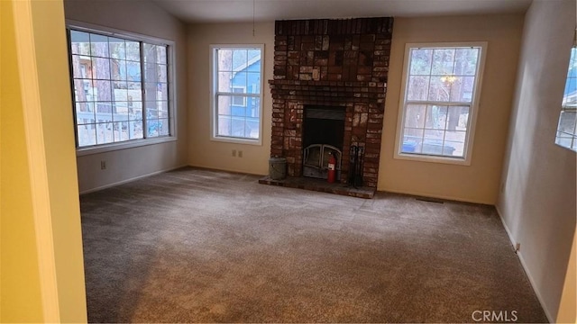 unfurnished living room with a fireplace and carpet floors