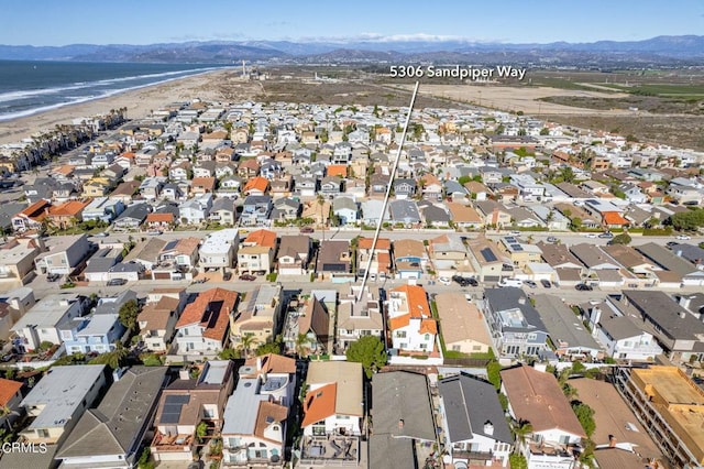 birds eye view of property with a water and mountain view