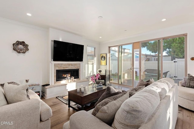 living room with light hardwood / wood-style flooring and crown molding