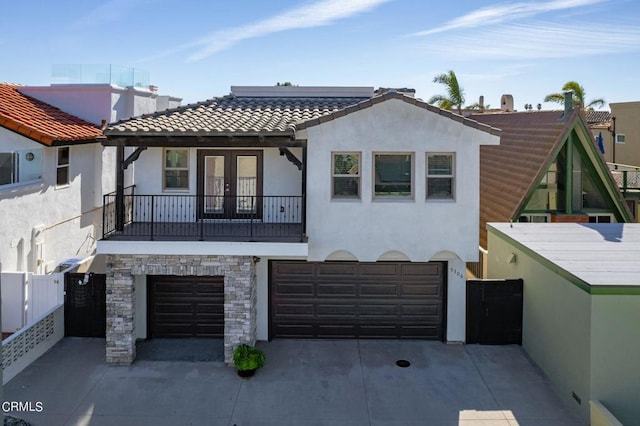 view of front facade featuring a balcony and a garage