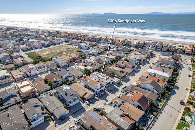 aerial view with a water view and a beach view