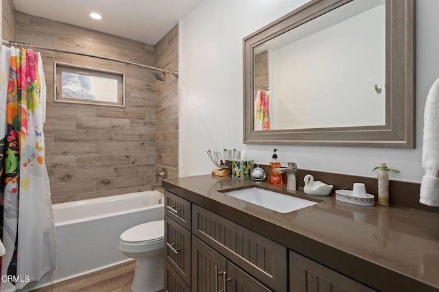 full bathroom featuring shower / tub combo, hardwood / wood-style flooring, vanity, and toilet