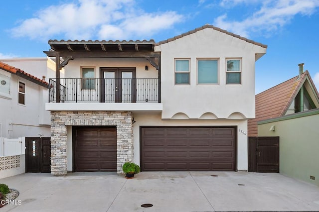 view of front of property featuring a balcony and a garage