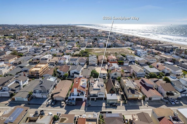 drone / aerial view with a beach view and a water view