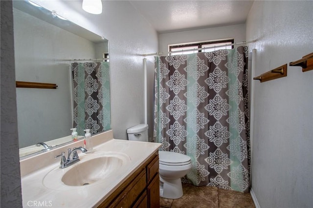 bathroom with vanity, curtained shower, and toilet