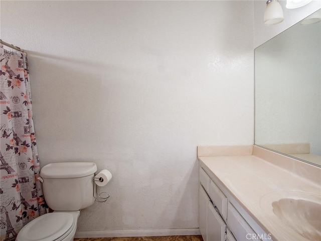 bathroom with vanity, toilet, and a shower with shower curtain