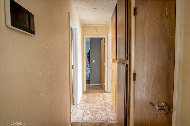 hallway featuring a textured ceiling