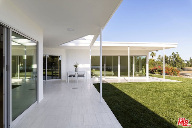 exterior space with a patio and a lawn